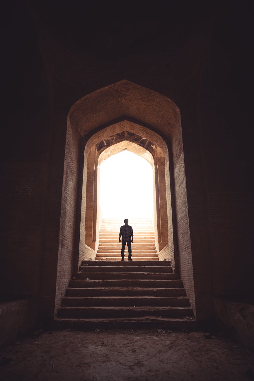 man standing between stairway on pathway